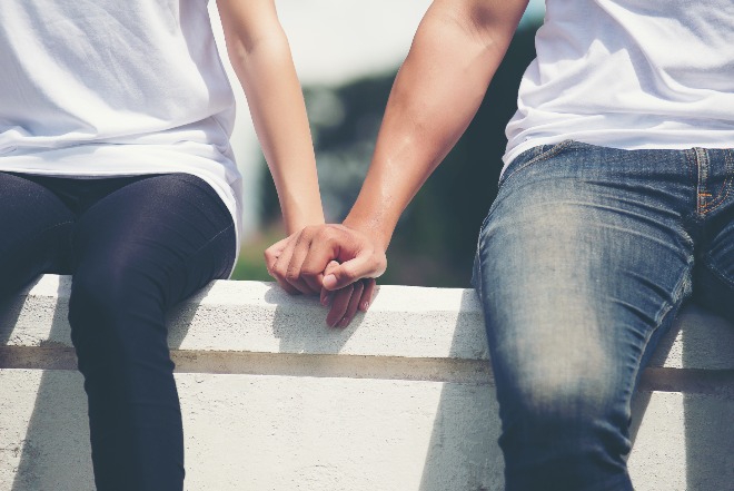 young-couple-holding-hands-walking-away-together.jpg